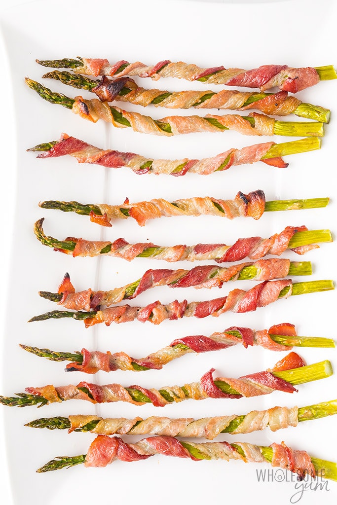Crispy Bacon Wrapped Asparagus Recipe in the Oven - This easy bacon wrapped asparagus recipe in the oven includes tricks for extra crispy bacon. Everyone loves these easy asparagus and bacon appetizers. And, bacon wrapped asparagus is naturally low carb, keto, paleo, and whole30 friendly.