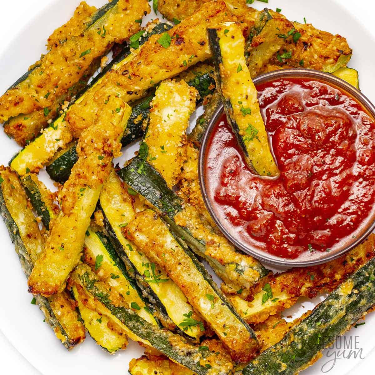 Zucchini fries on a plate with marinara.