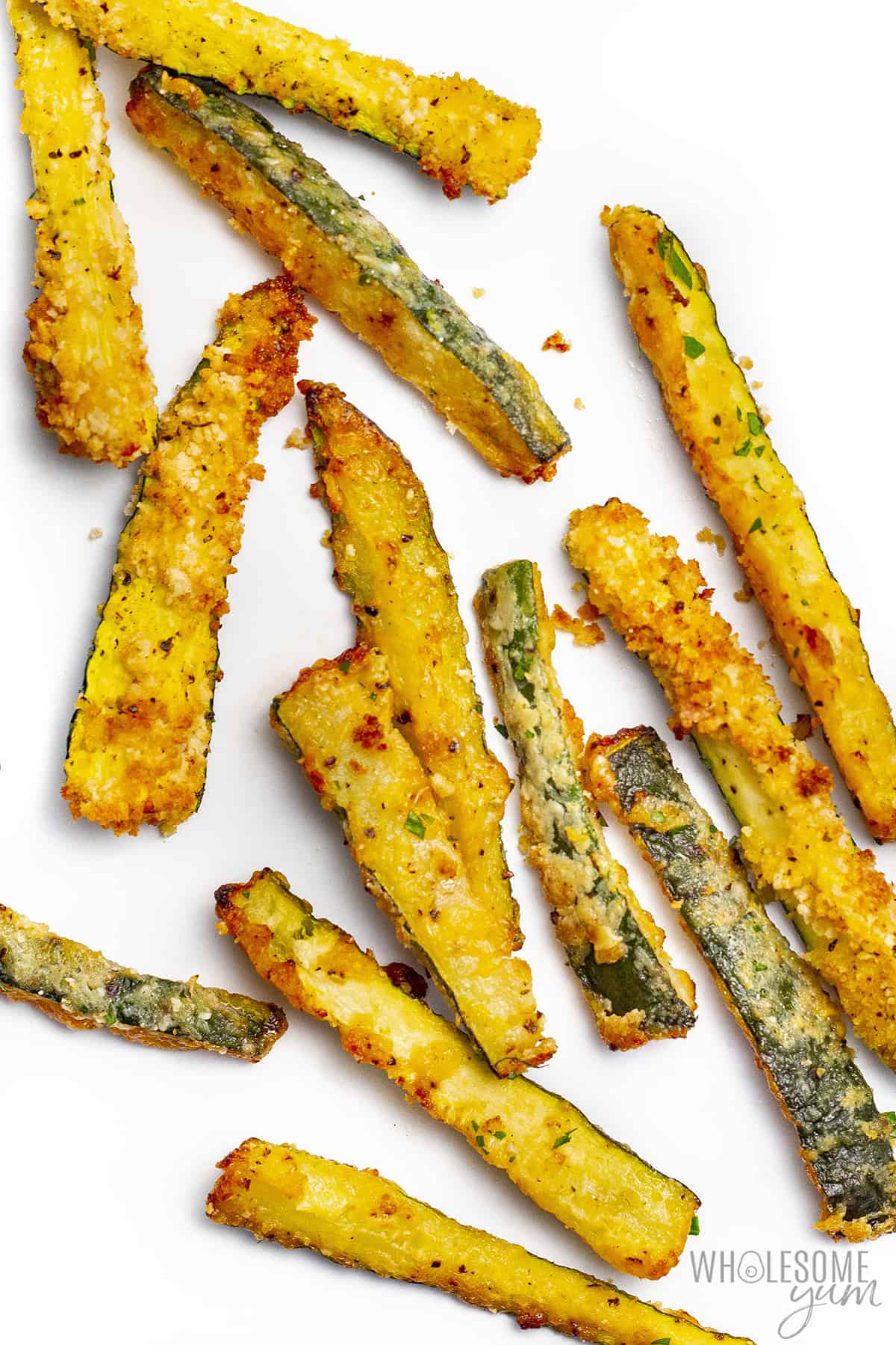 Zucchini fries recipe on a white surface.