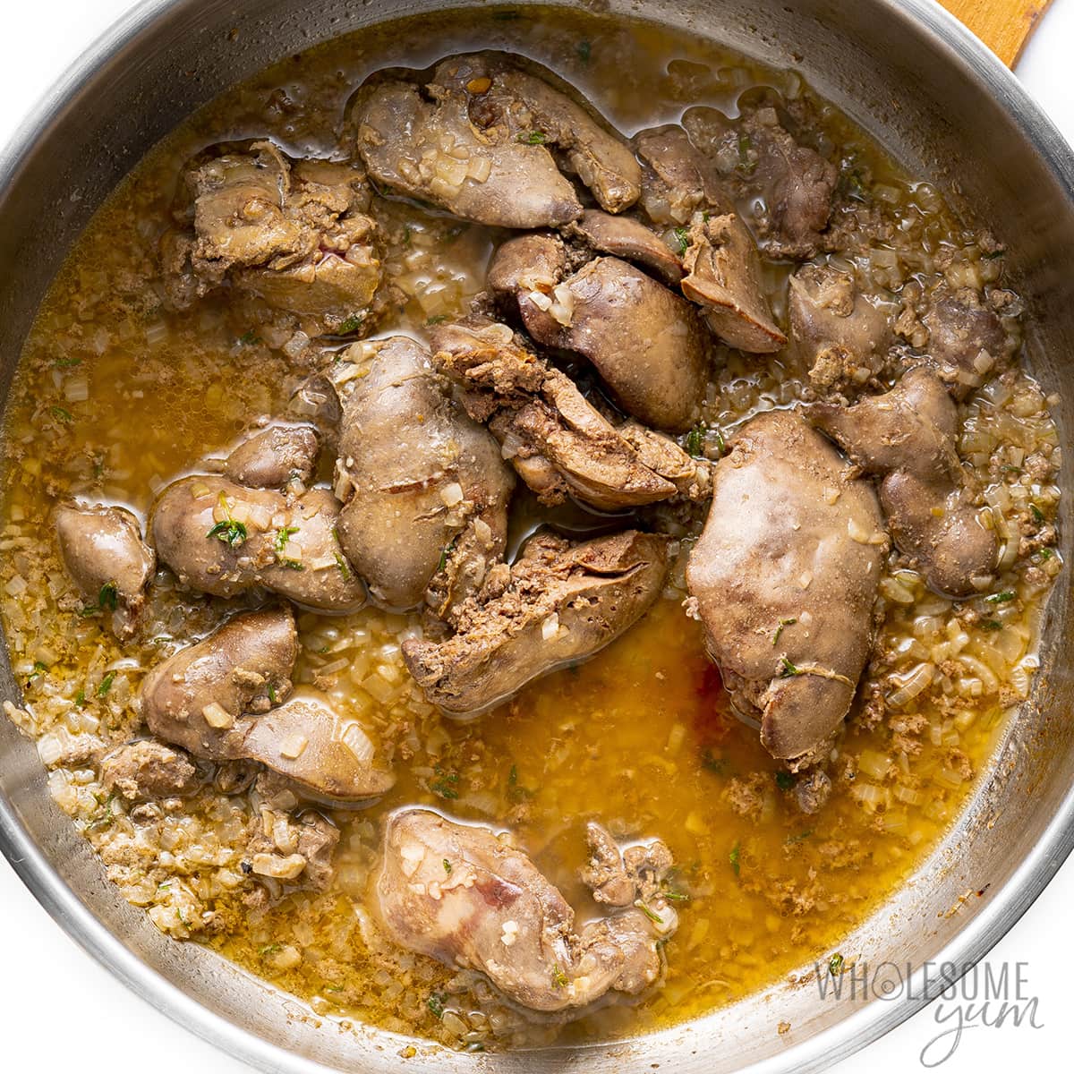 Cooked chicken livers in a skillet. 