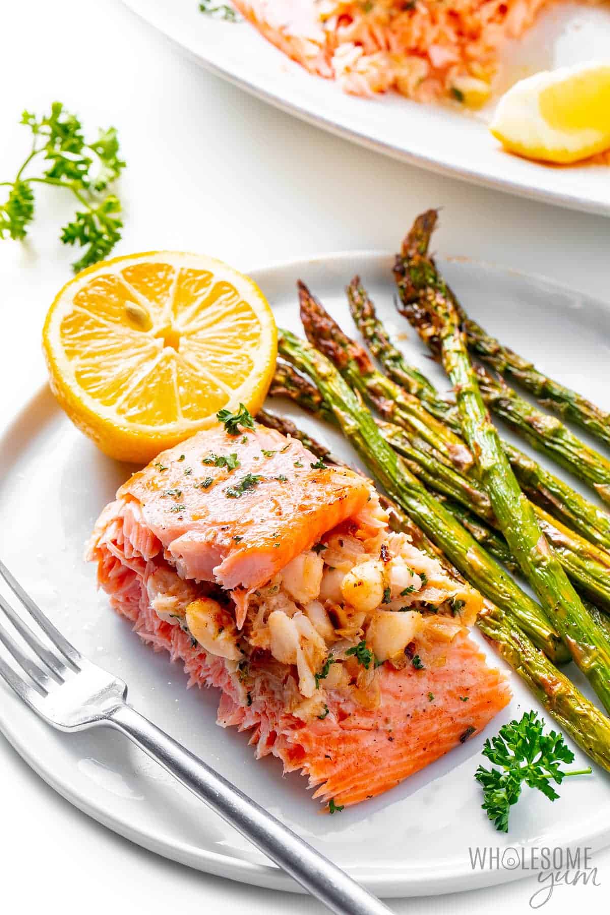 Plated crab stuffed salmon with asparagus.