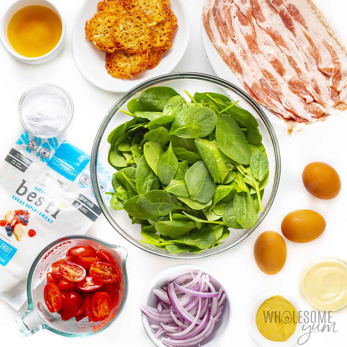 Ingredients for spinach salad with bacon dressing in bowls.