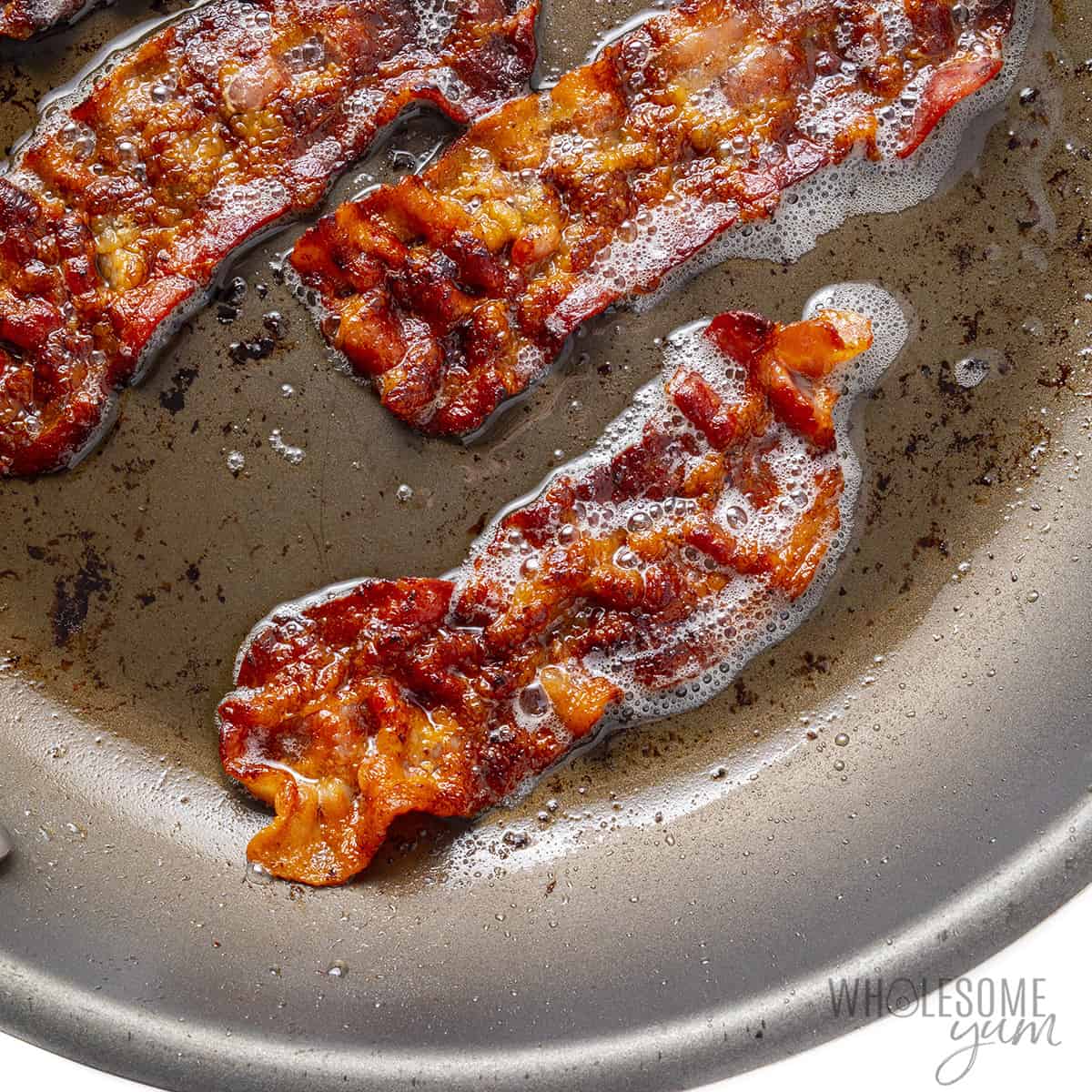 Bacon cooking in a pan.