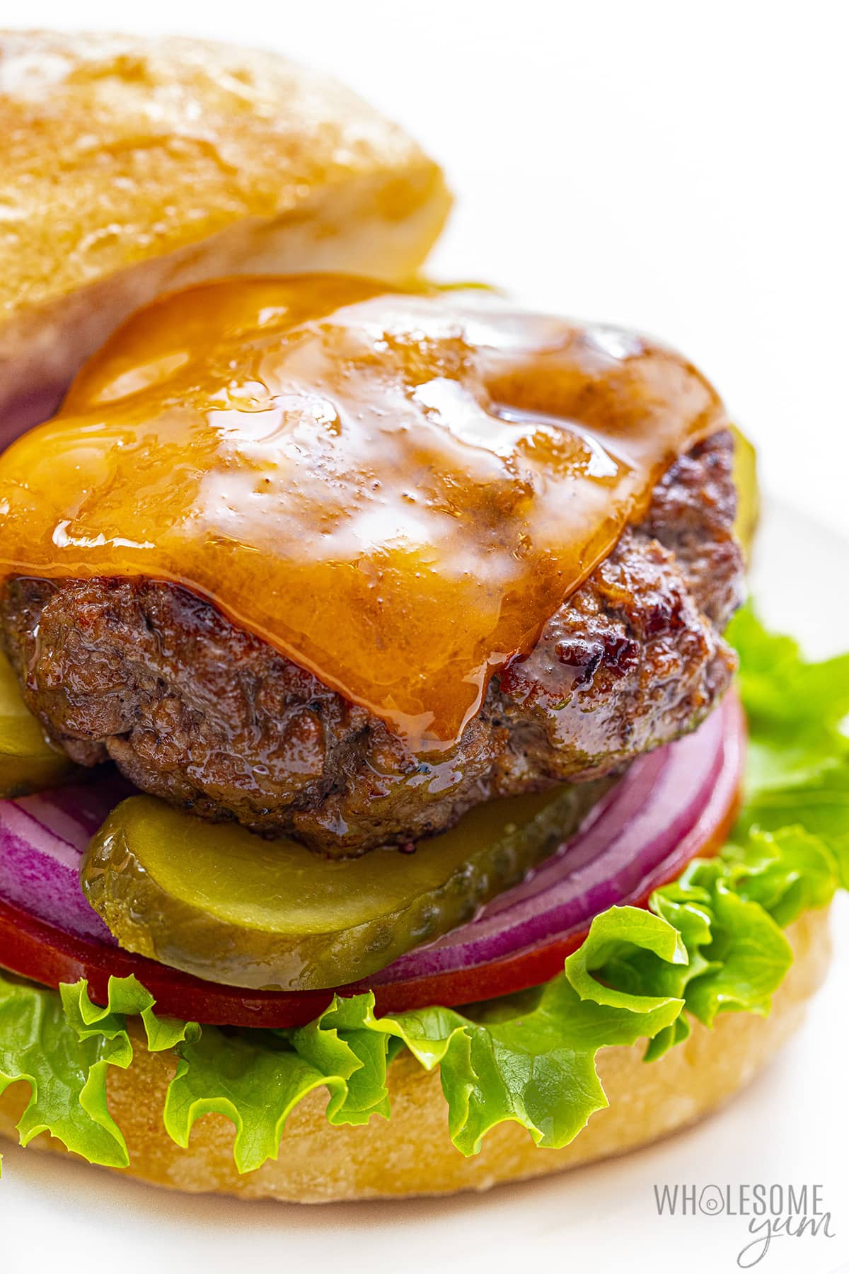 Juicy burger with cheese and fixings on a bun.