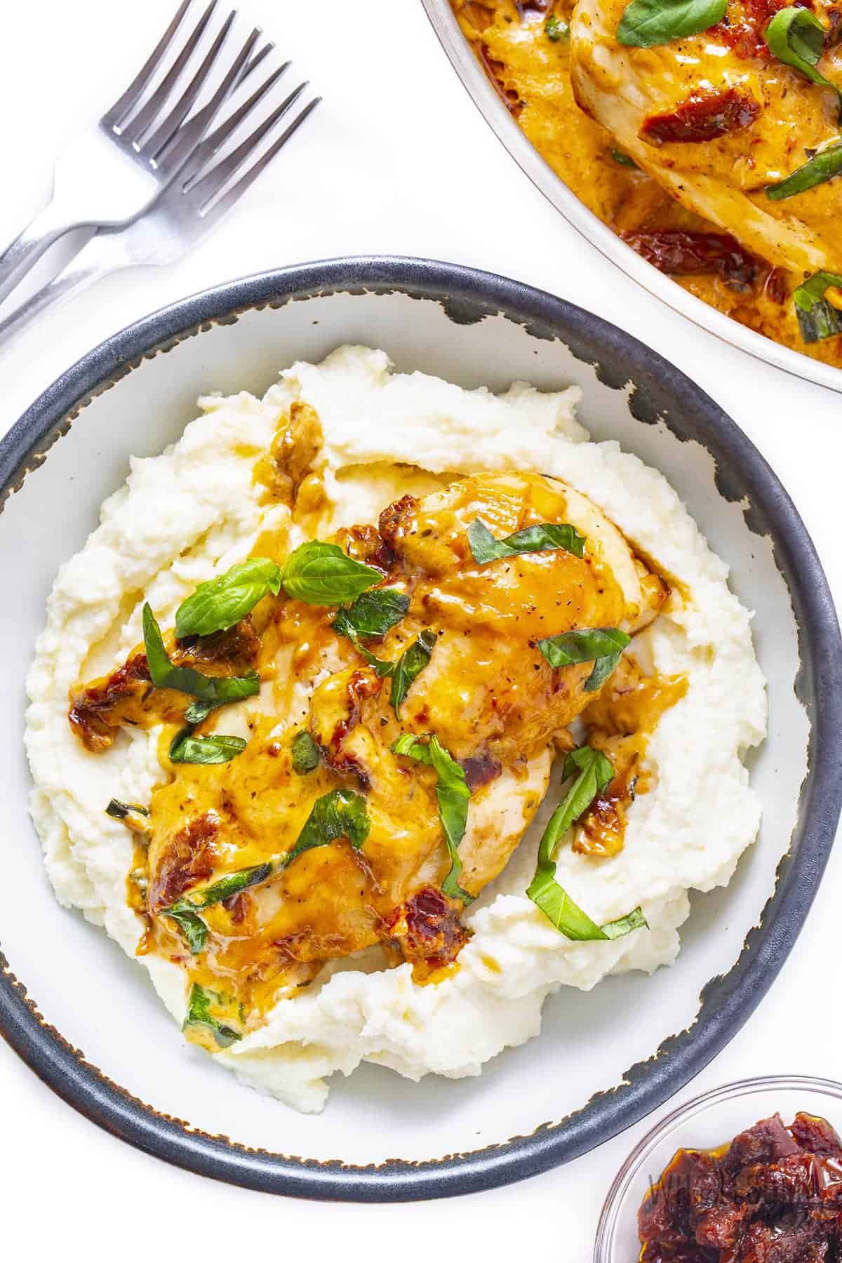 Creamy chicken with sun-dried tomatoes and basil over cauliflower mash