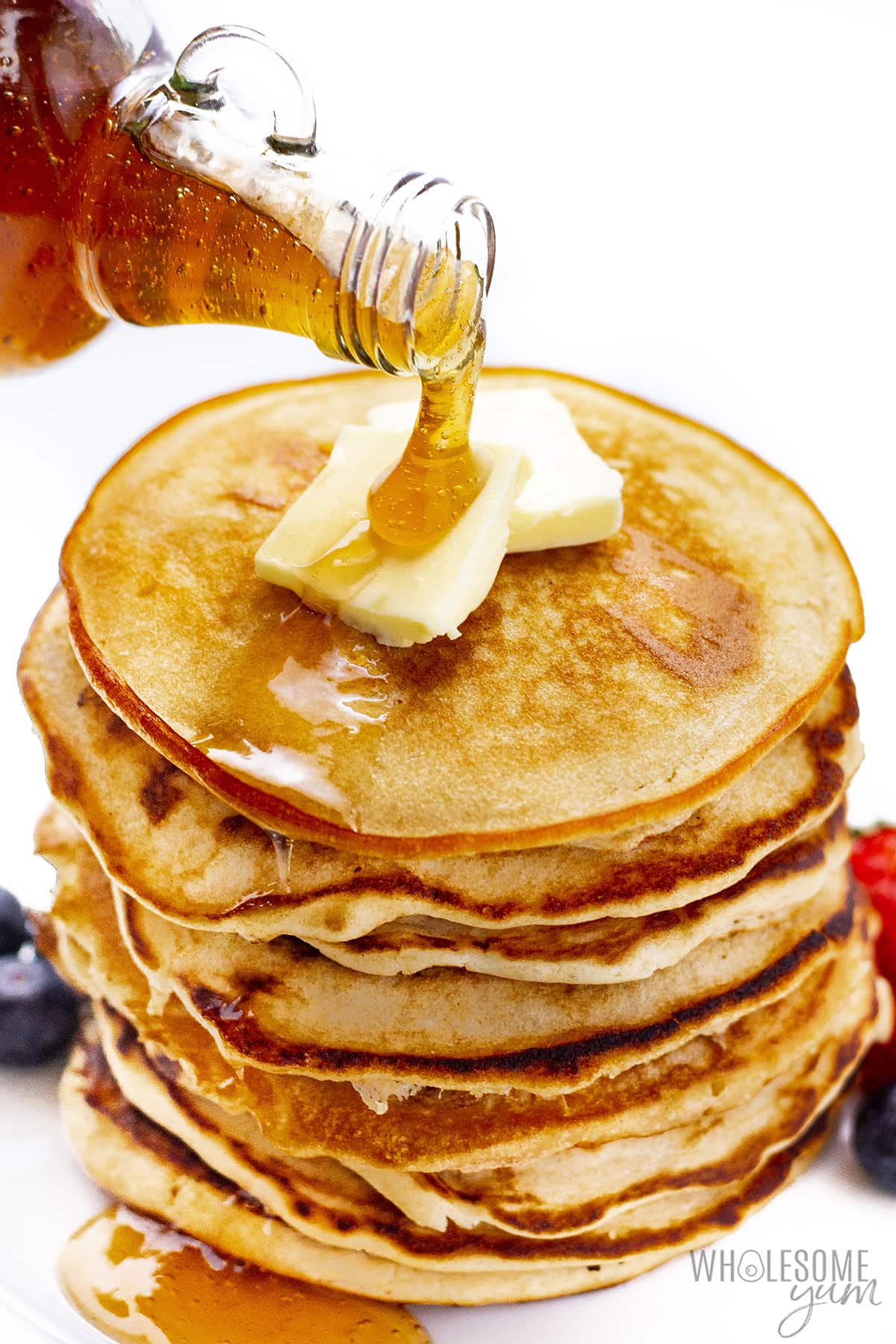 Pouring sugar free maple syrup over pancakes.