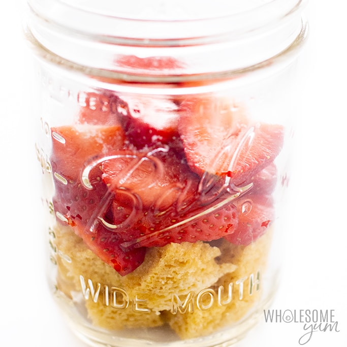 putting together layers of strawberry shortcake in a jar