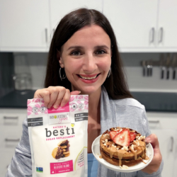 Maya with a plate of peanut butter waffles and Besti.