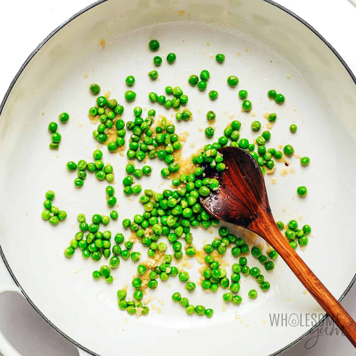 Sauteed peas and garlic in the skillet.