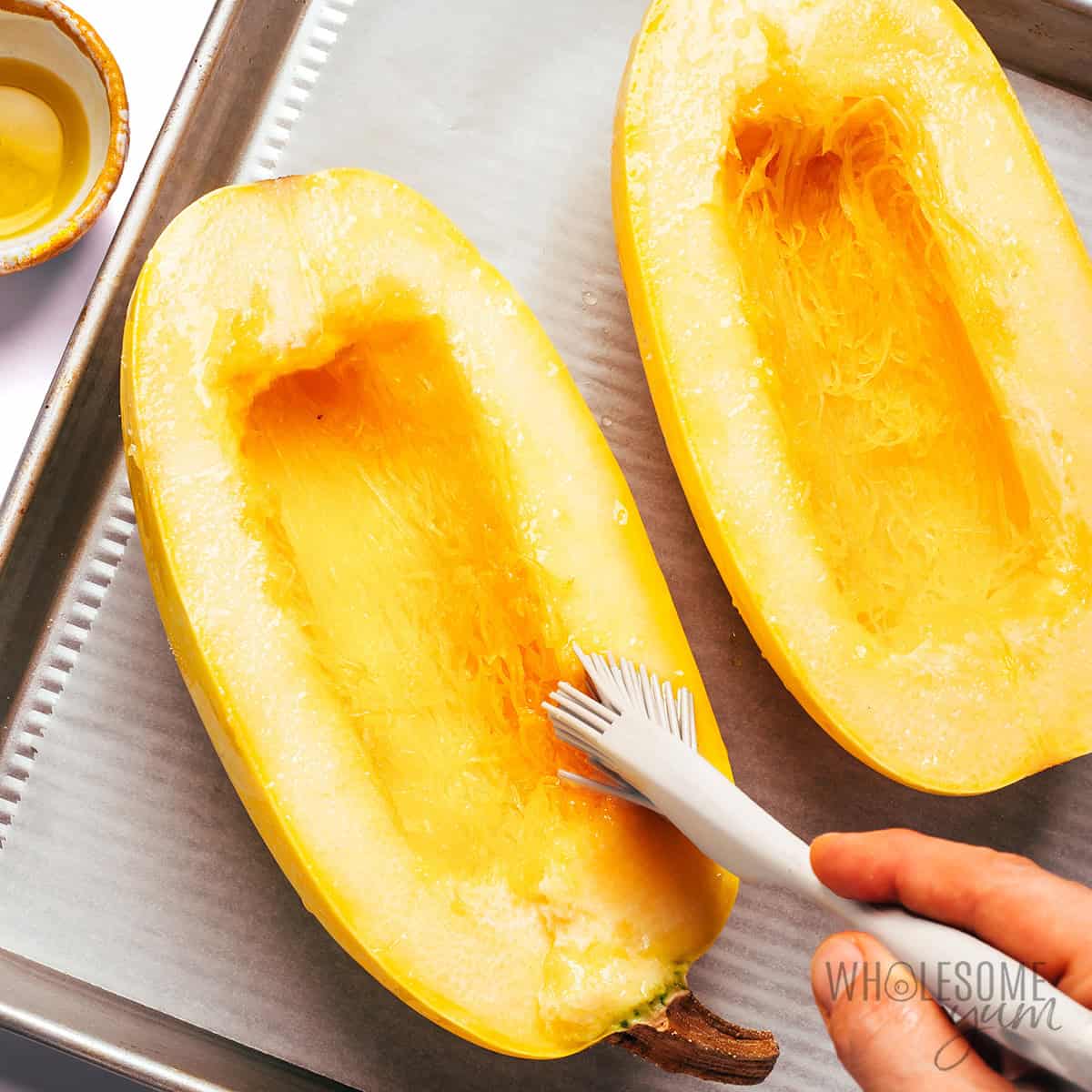 Spaghetti squash halves brushed with oil.