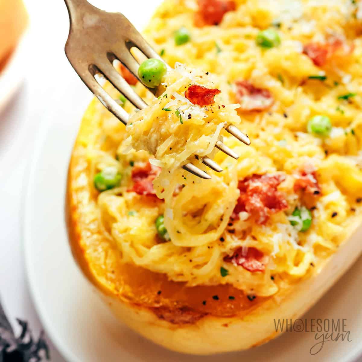 Creamy spaghetti squash carbonara with crispy bacon and green peas.
