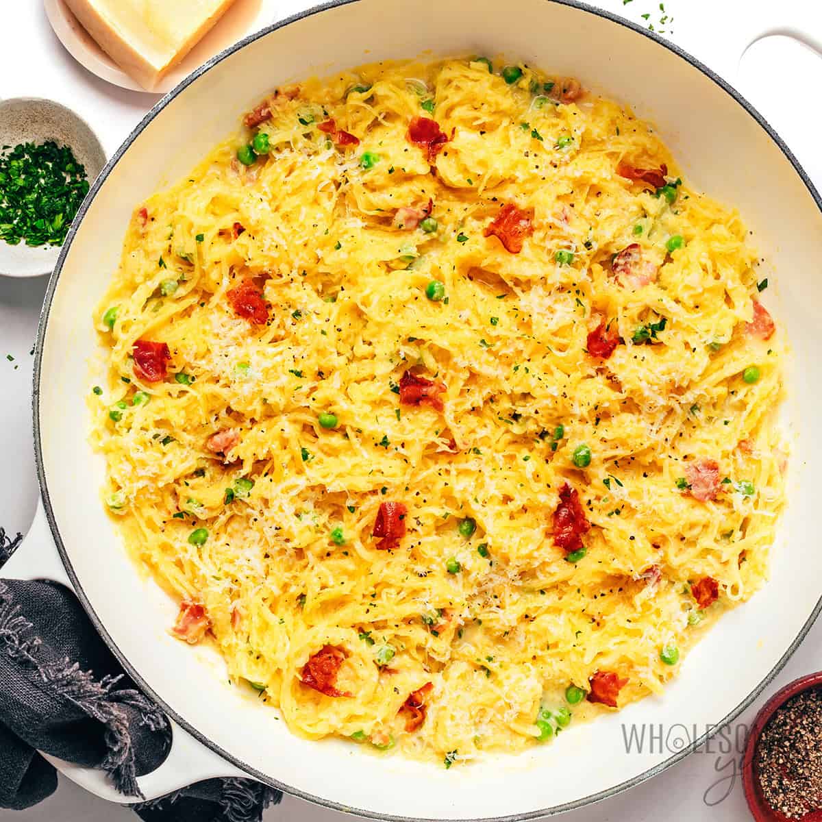 Spaghetti squash carbonara recipe topped with crispy bacon and Parmesan cheese.