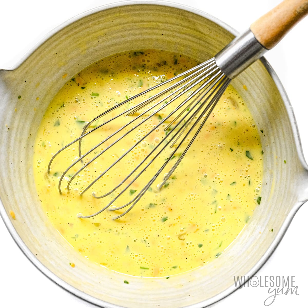 Eggs, cream, cheese, parsley, salt, and pepper whisked in mixing bowl. 