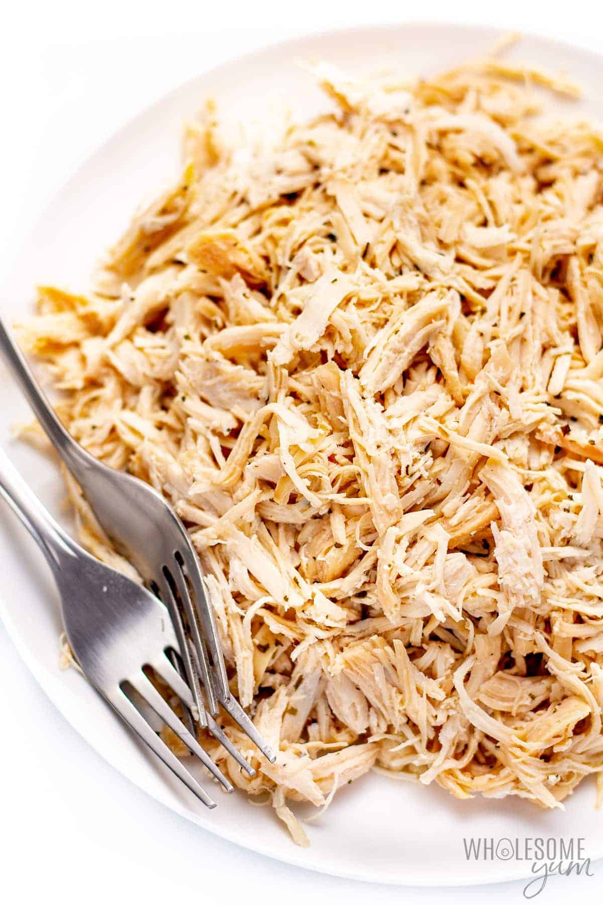 Shredded Instant Pot chicken breast on a plate.
