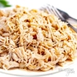 Instant Pot chicken breast, shredded and piled on a plate.