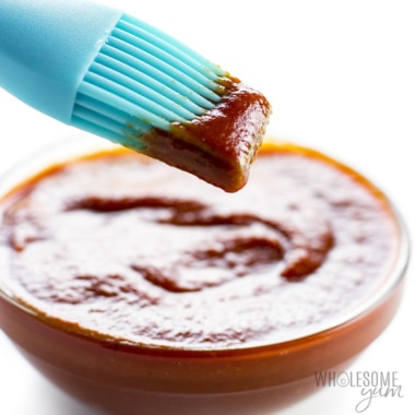 Sugar free BBQ sauce in a bowl with a basting brush.