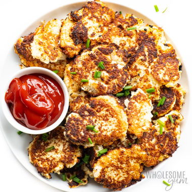 Cauliflower hash browns  on a plate with dipping sauce
