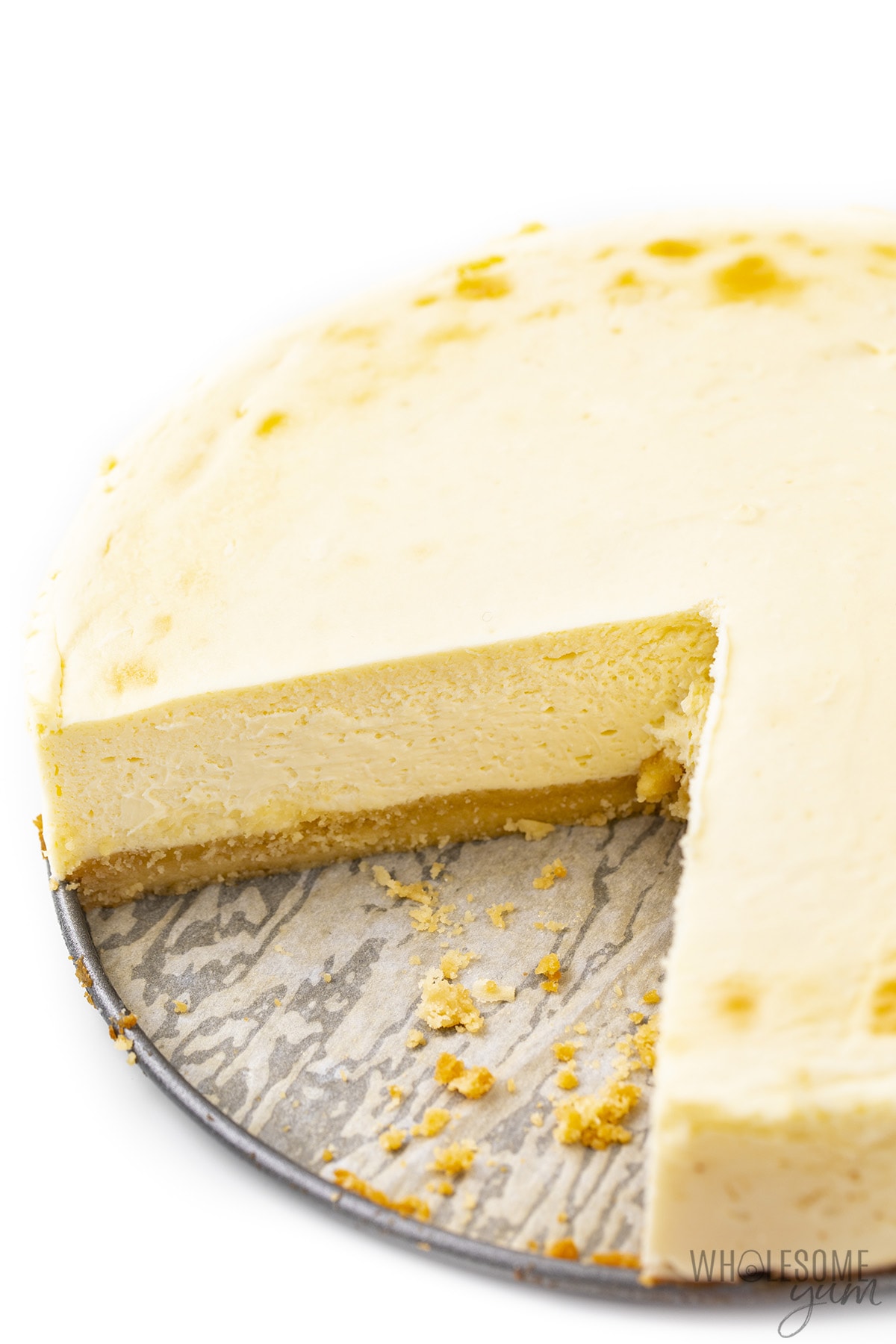 Classic sugar-free cheesecake with slice removed.