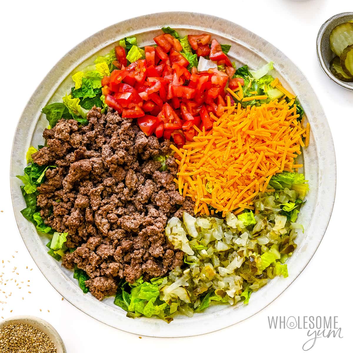 Hamburger salad in a bowl without dressing.