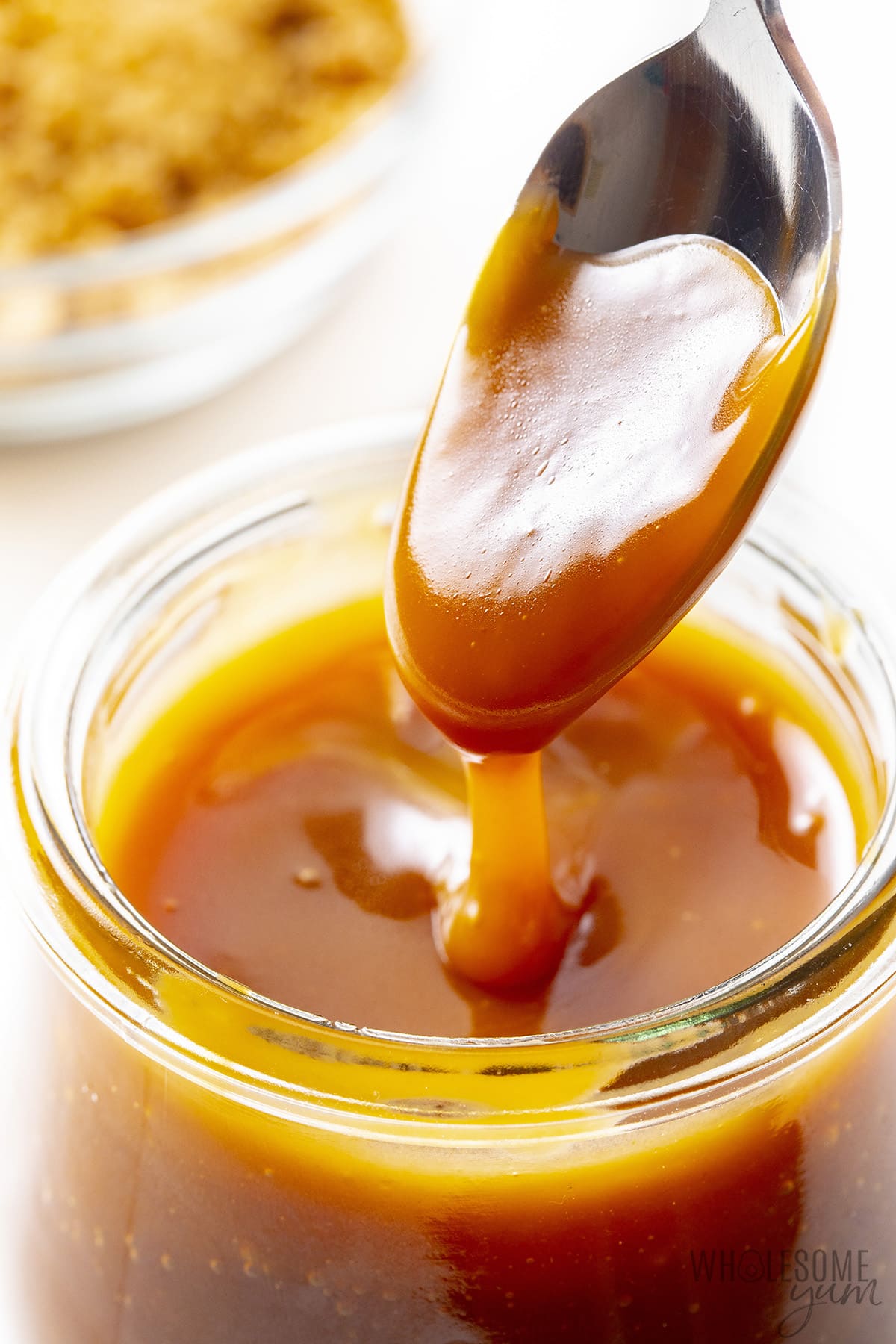 Sugar-free caramel sauce on a spoon.