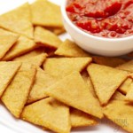Keto chips on a plate with bowl of salsa.