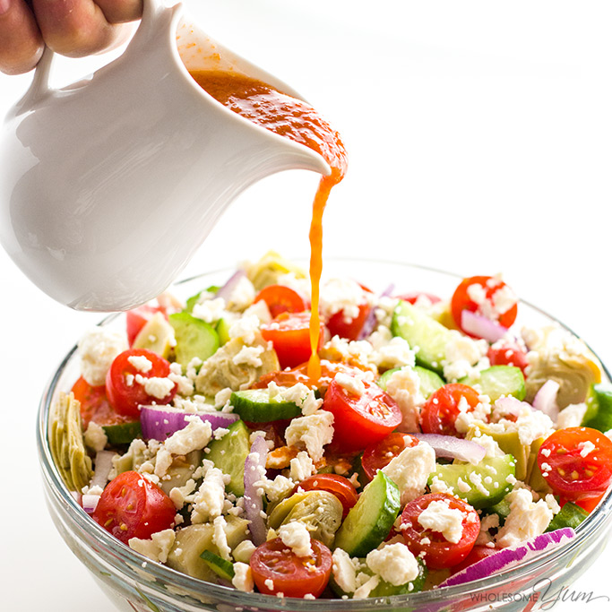 Mediterranean Salad Recipe in bowl with dressing pouring