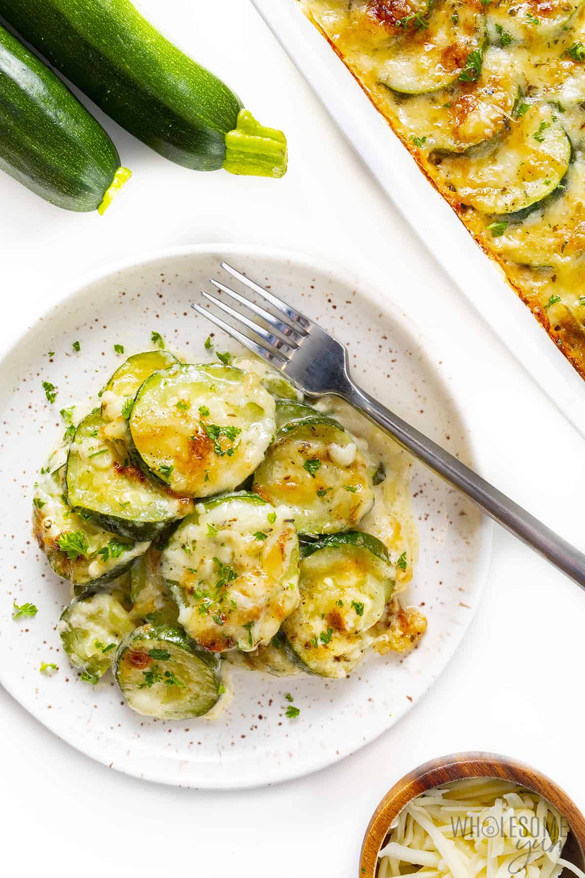 Zucchini casserole plated with a fork.