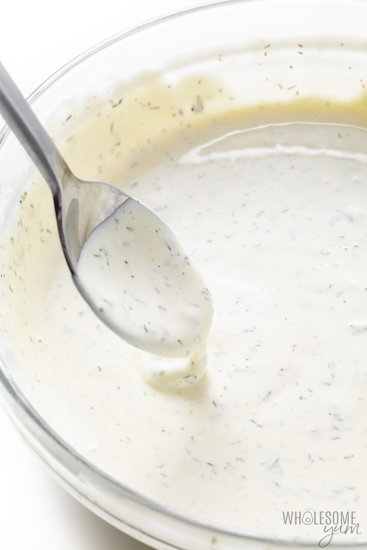 Ranch dressing recipe dripping from a spoon.