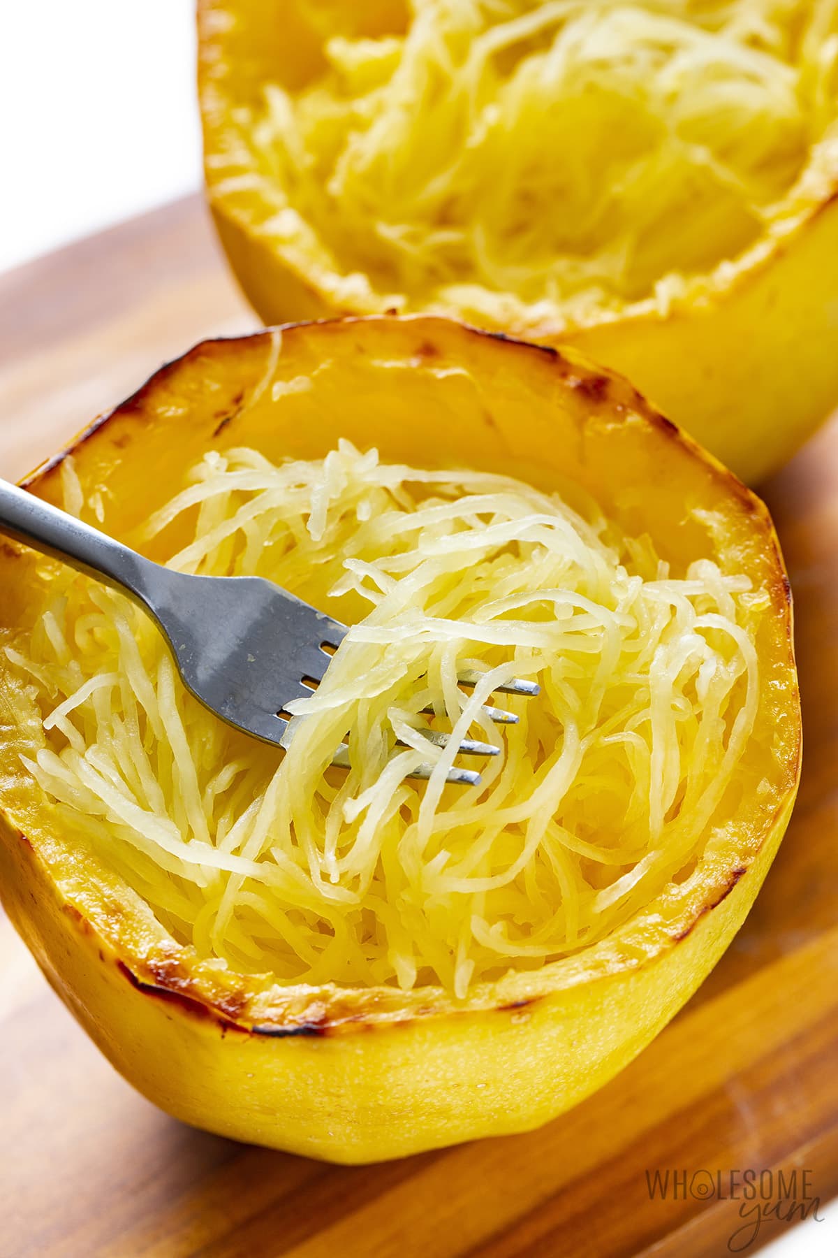 Picking up spaghetti squash strands with a fork.