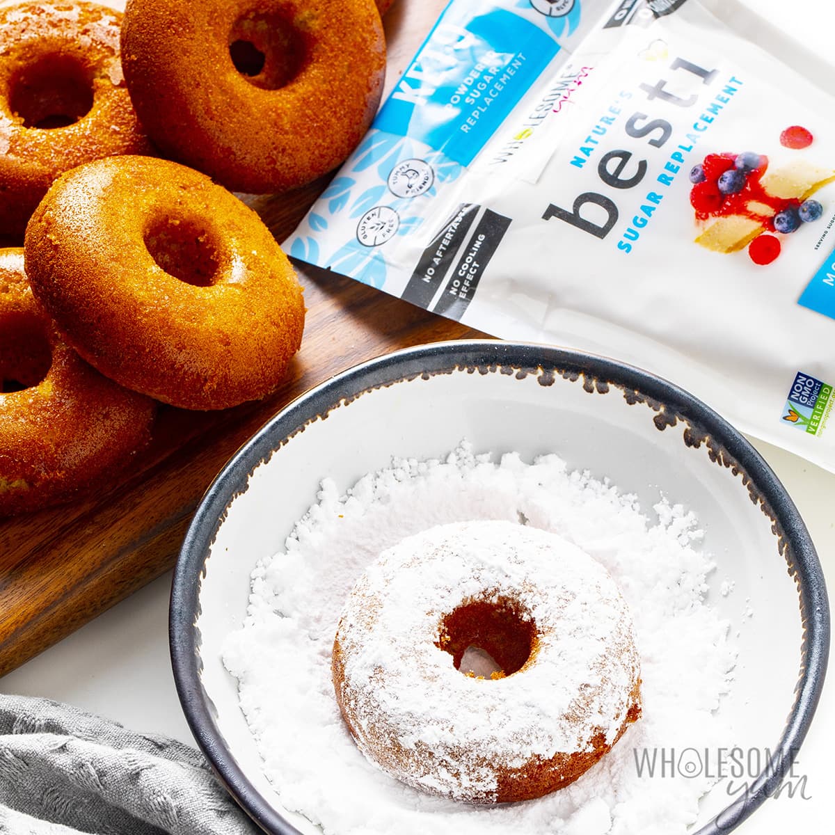 Keto donuts being dipped in powdered Besti.