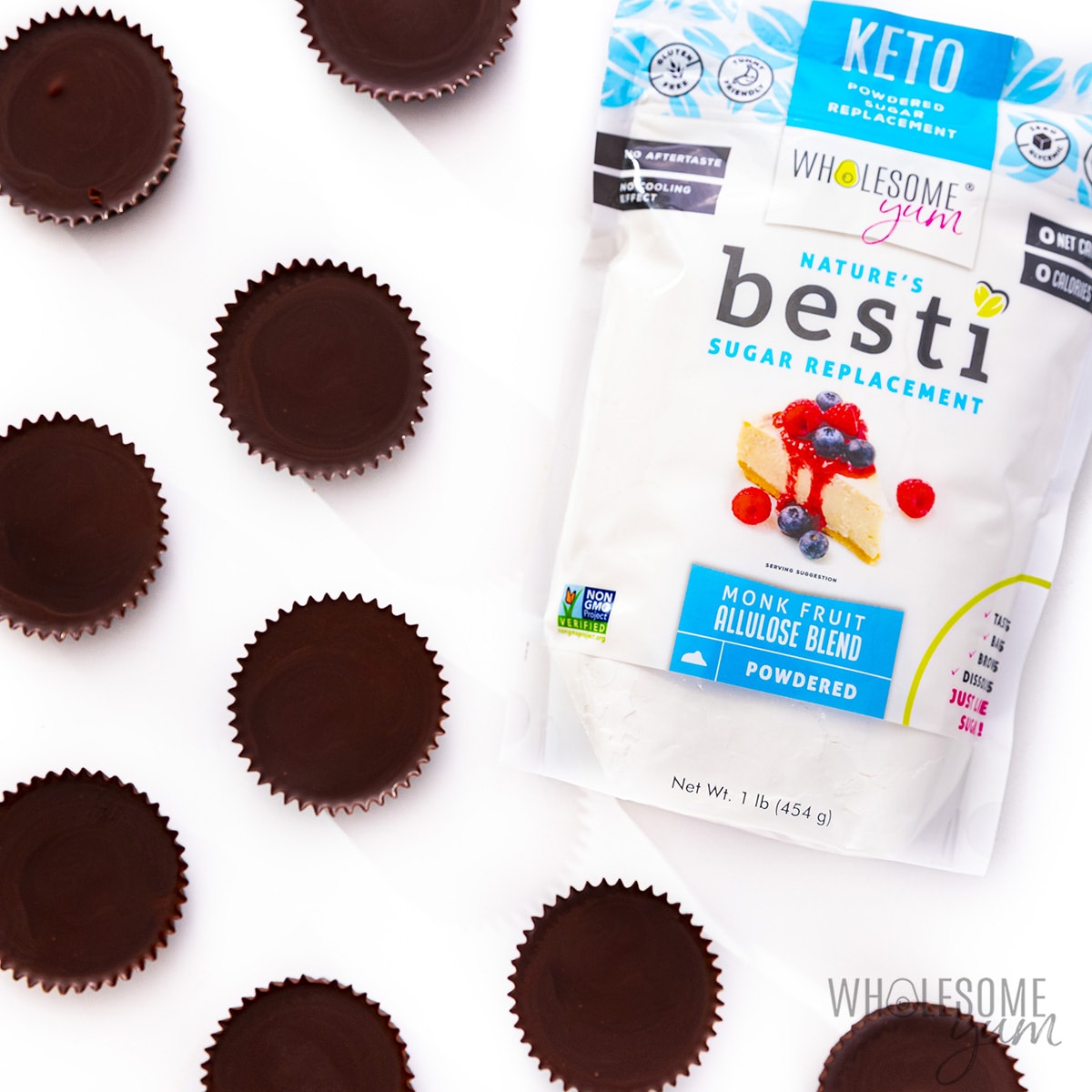 Finished keto peanut butter cups on white background next to Besti.