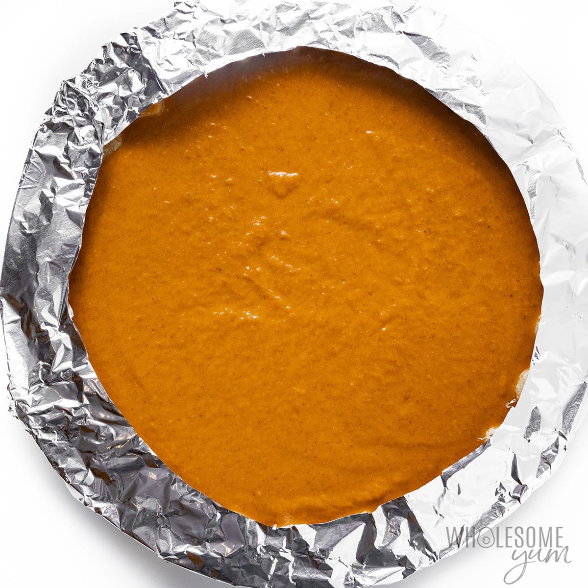 Low carb pumpkin pie with foil around the edges.