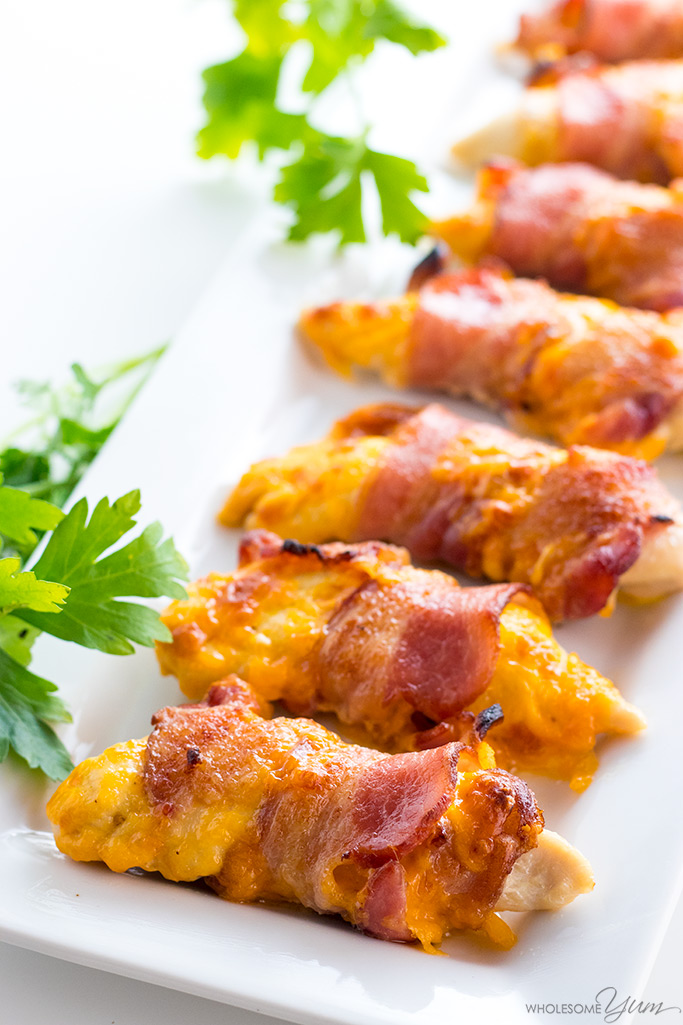 Baked Bacon Wrapped Chicken Tenders Recipe - 3 Ingredients - This easy baked bacon wrapped chicken tenders recipe needs just 3 common ingredients - chicken, bacon, and cheese! Ready in under 30 minutes.