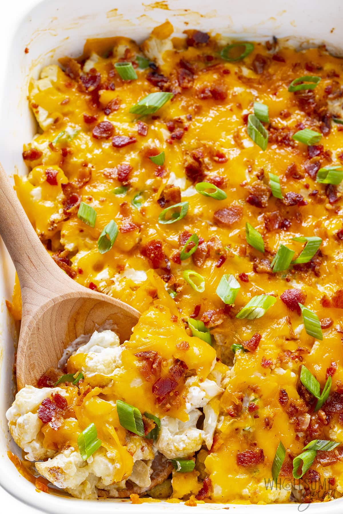Loaded cauliflower casserole with serving spoon.