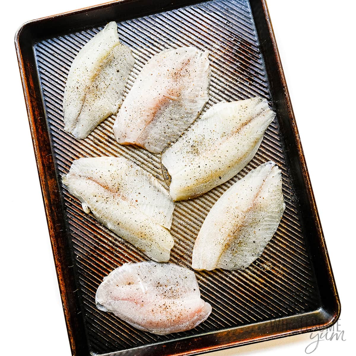 Tilapia fillets seasoned with salt and pepper.