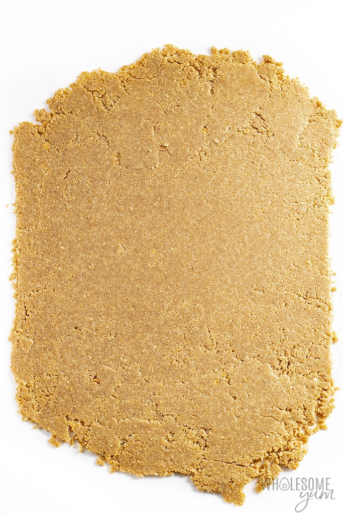 Gluten-free graham cracker dough rolled out on a piece of parchment paper