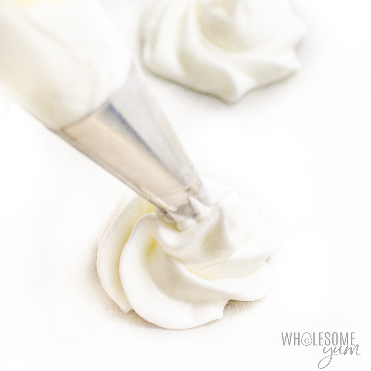 Pipe meringue mixture onto parchment paper.
