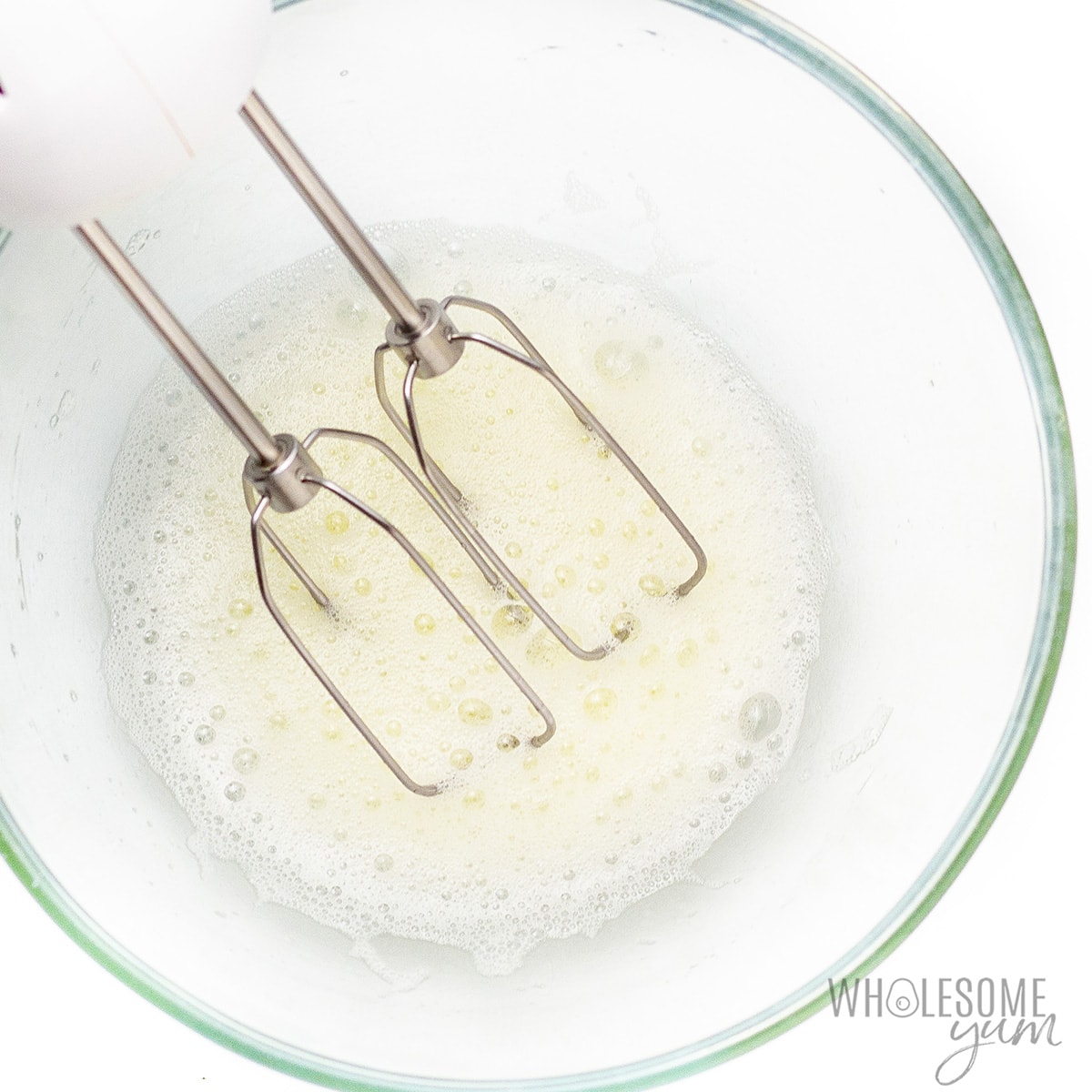 Whisk egg whites in a bowl until foamy.
