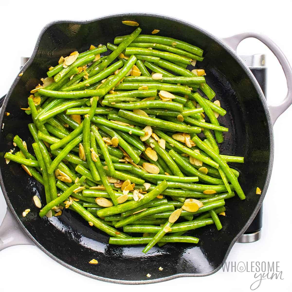 Green beans with almonds in skillet.