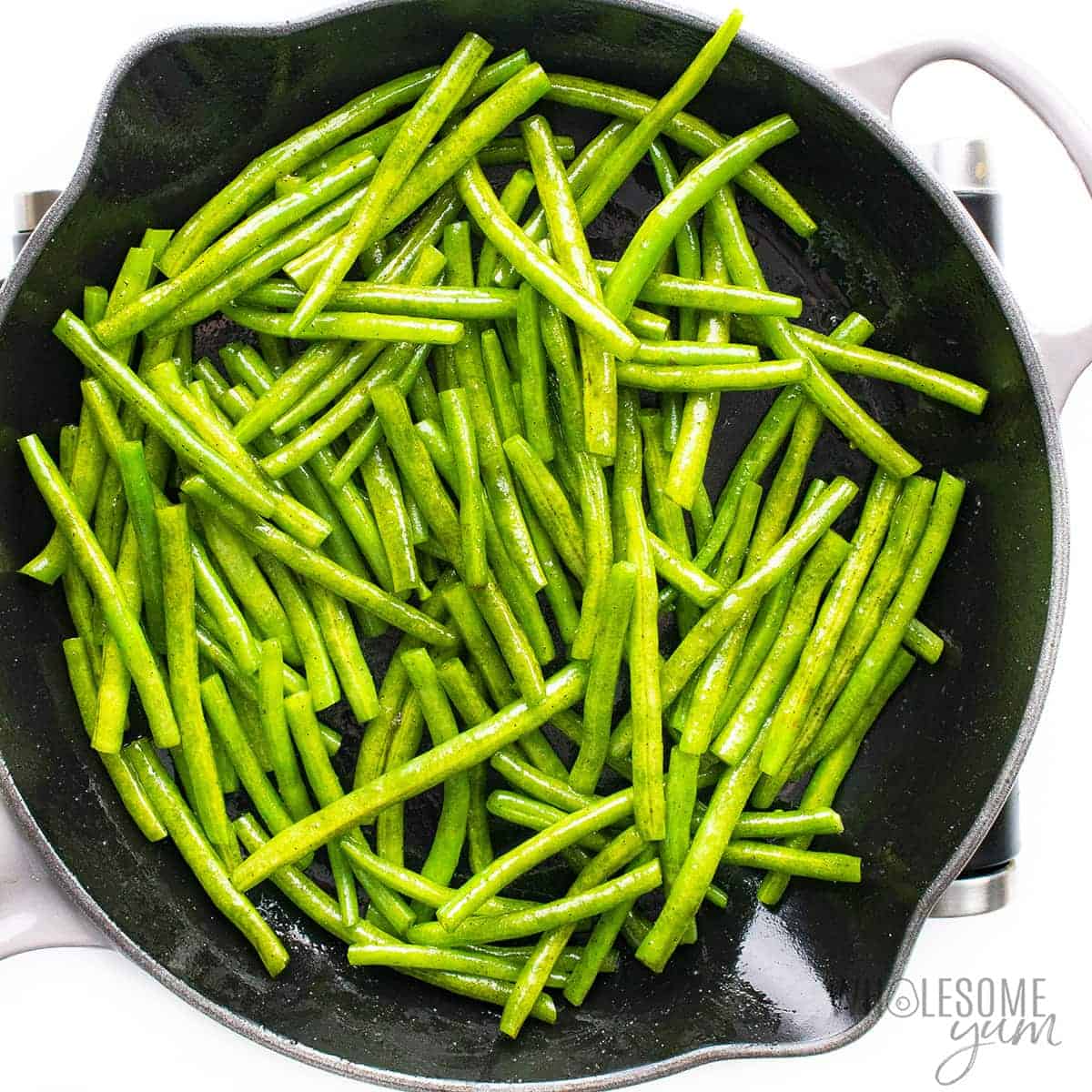 Green beans cooking in a skillet.