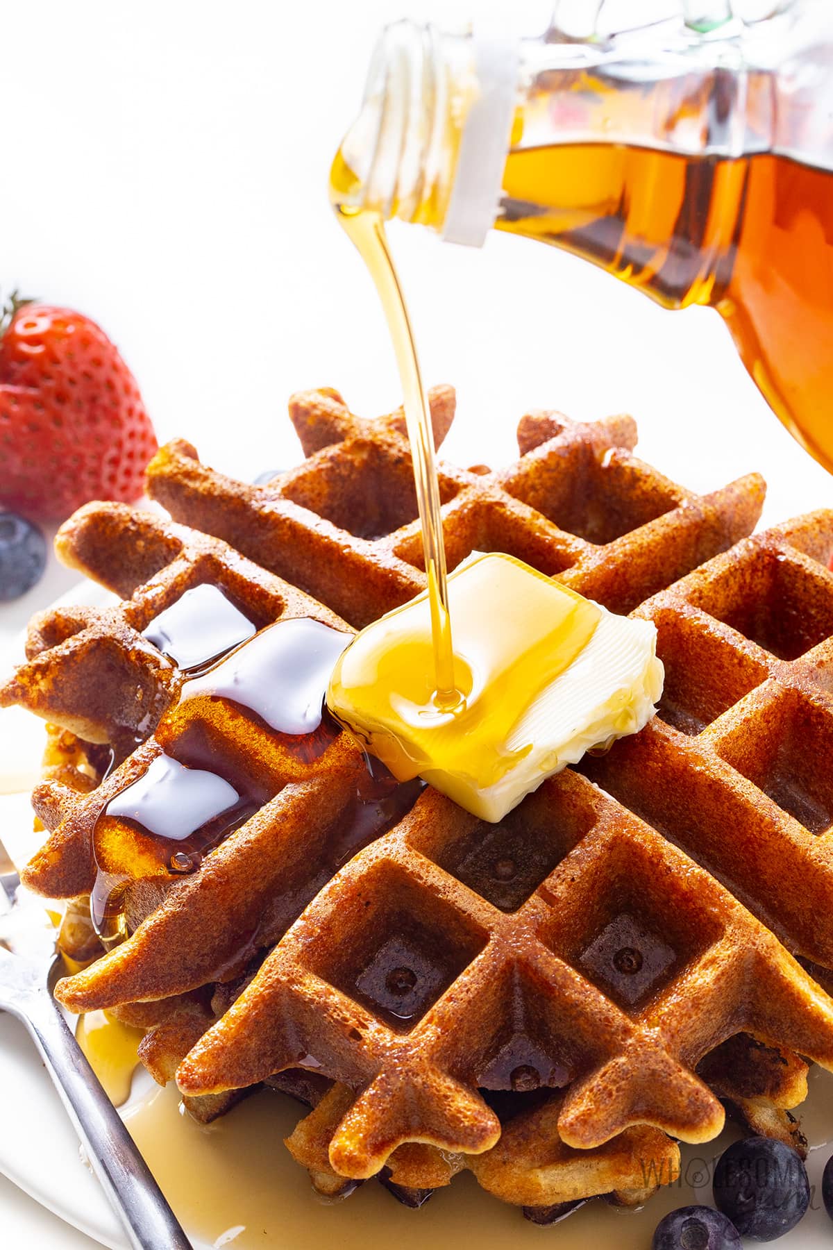 Keto almond flour waffles with butter and sugar-free syrup.
