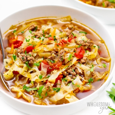 Beef cabbage soup recipe with hamburger close up in a bowl.