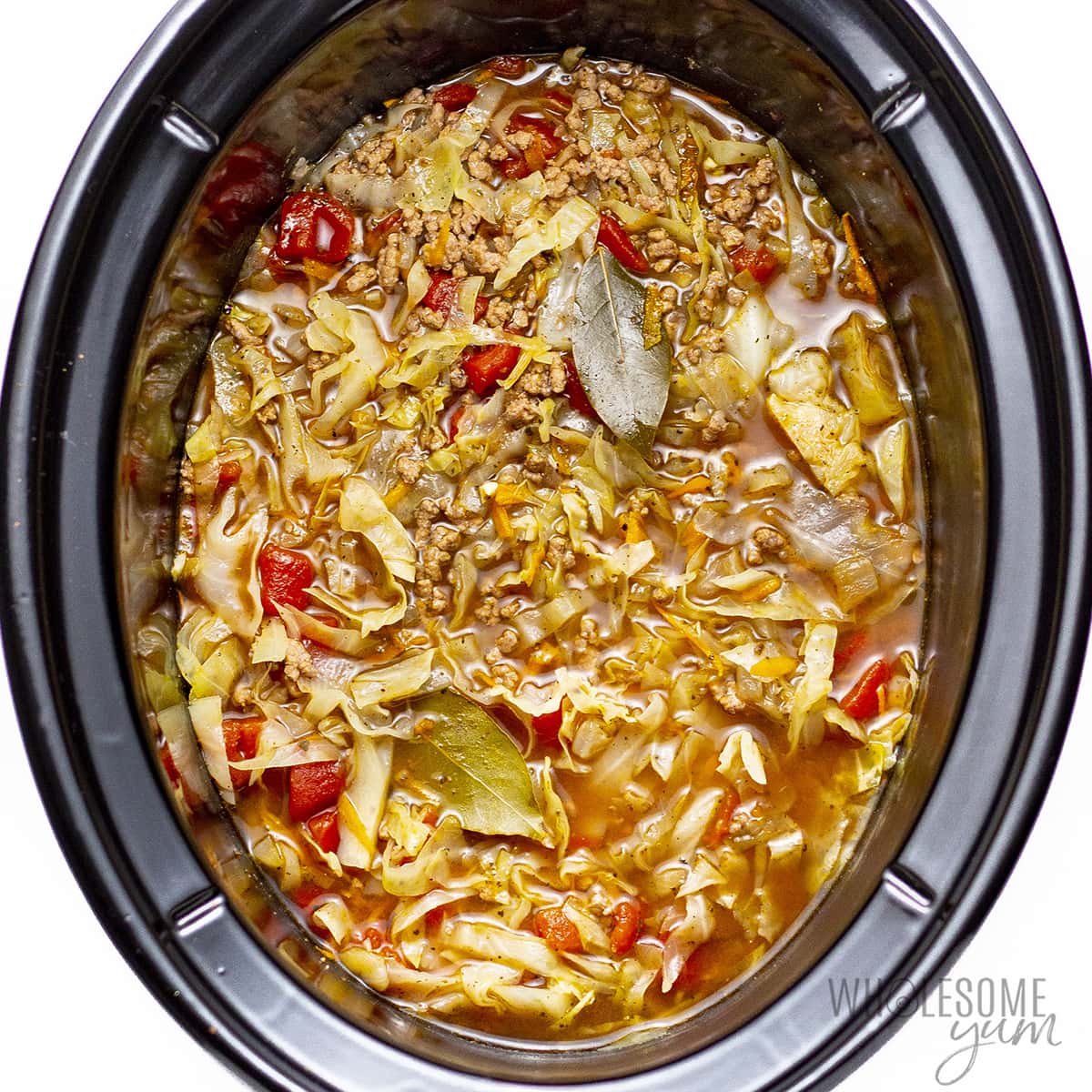 Fully cooked cabbage soup in Crock Pot.