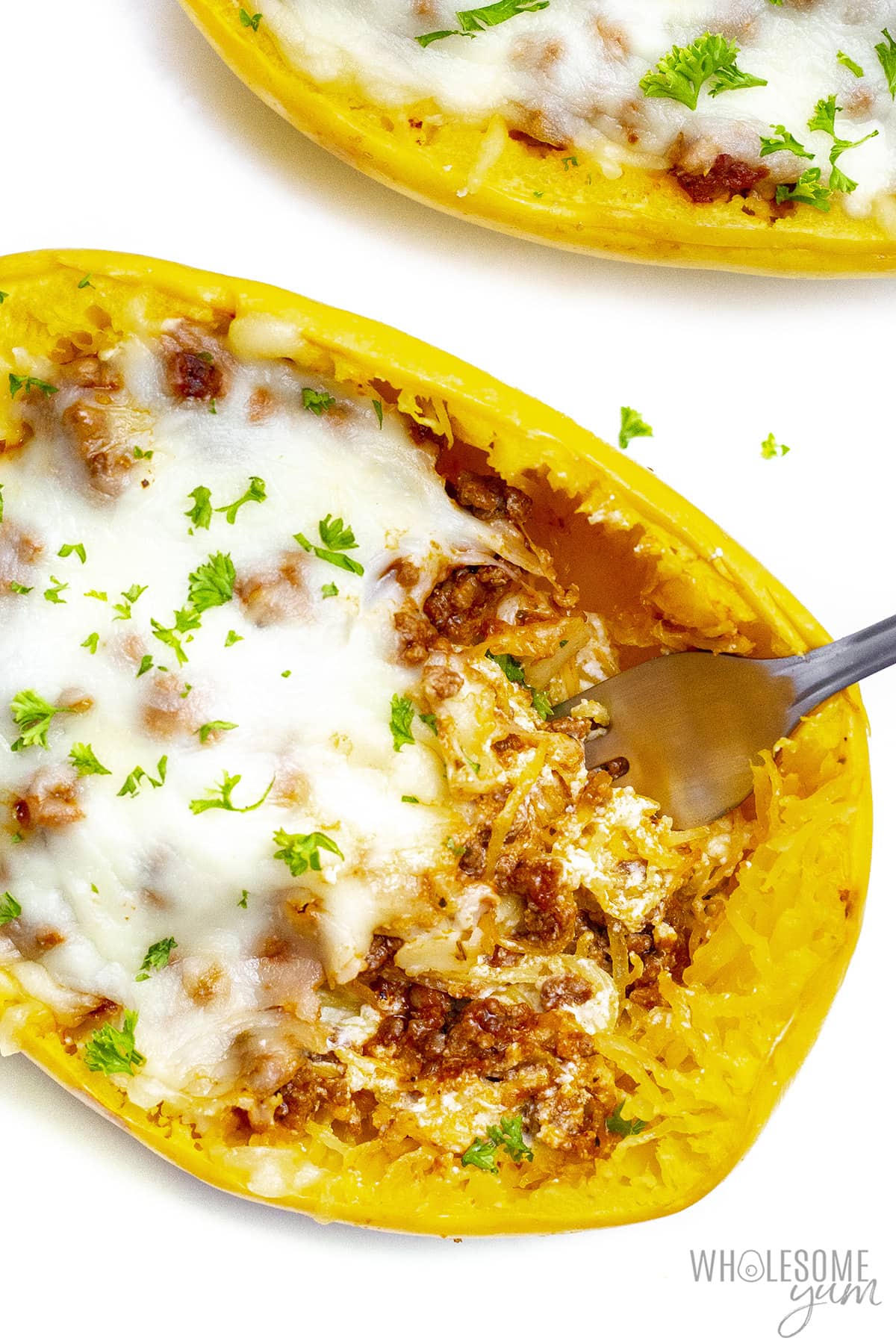 Stuffed spaghetti squash with some noodle mixture removed.