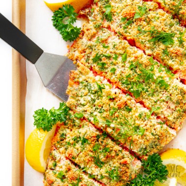 Parmesan crusted salmon with lemon wedges