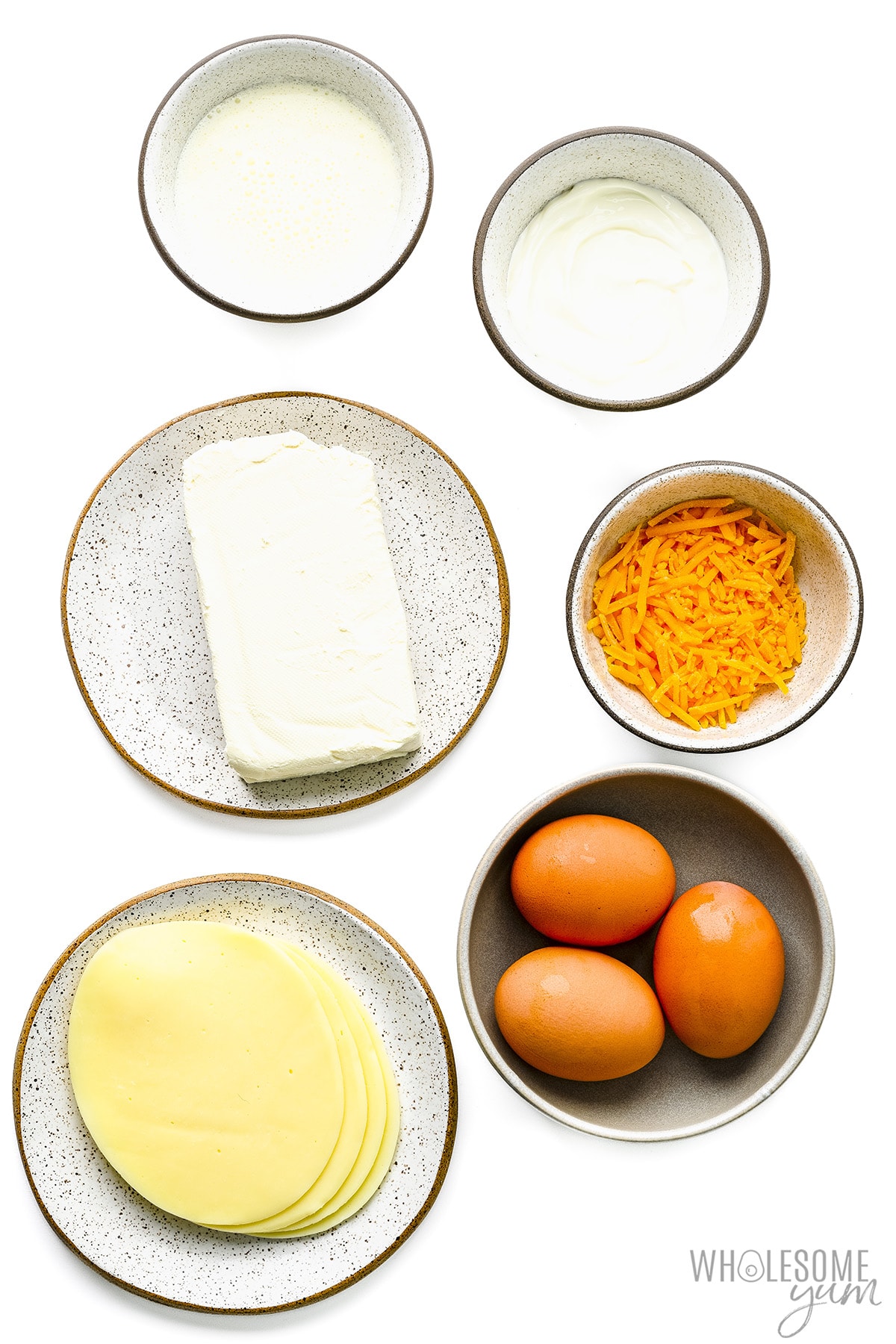 Eggs and low carb dairy on white background.