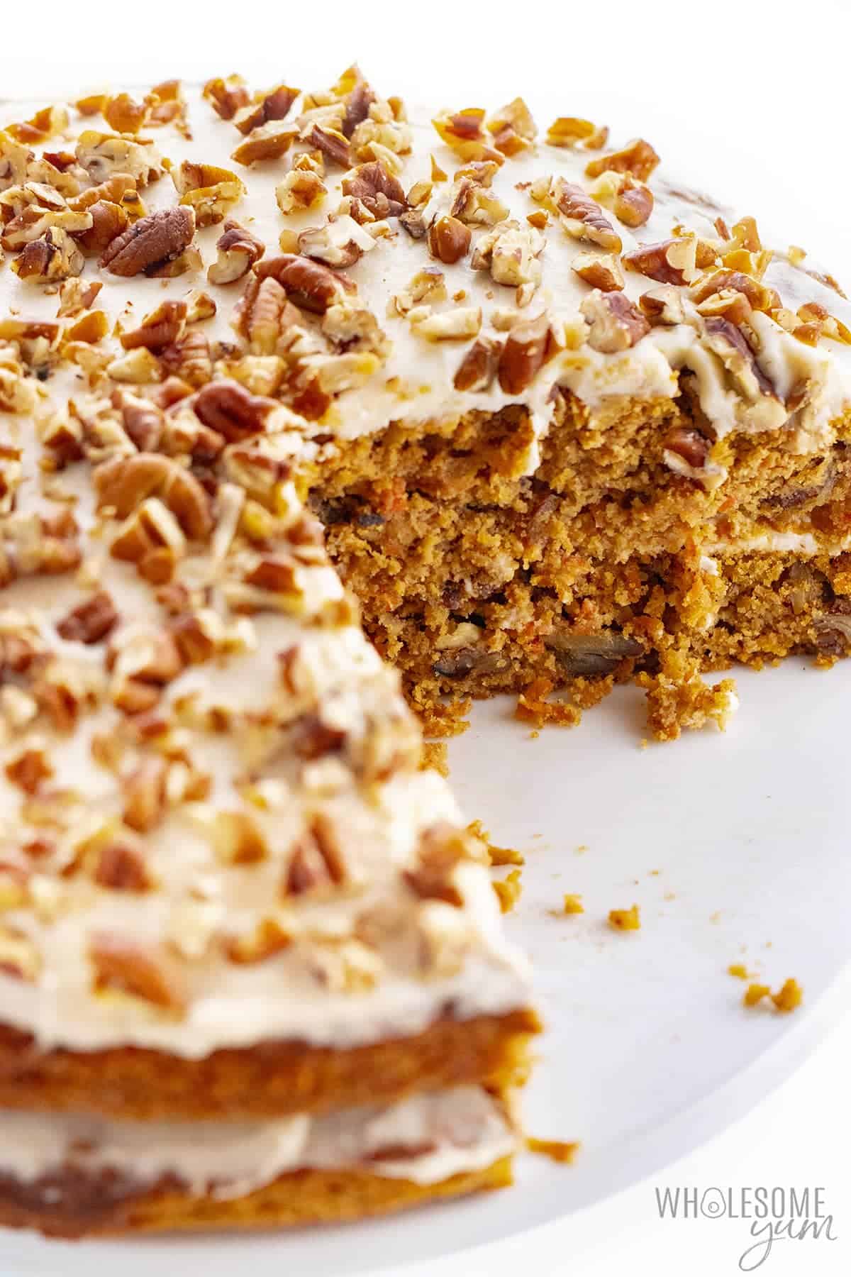 Sugar-free low carb carrot cake with a few slices removed.