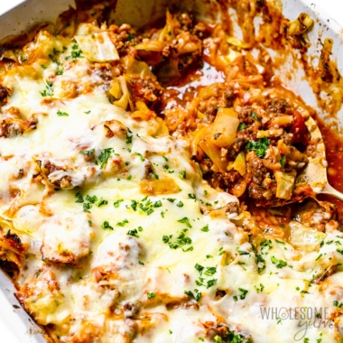 Cabbage roll casserole in a baking dish with spoon.
