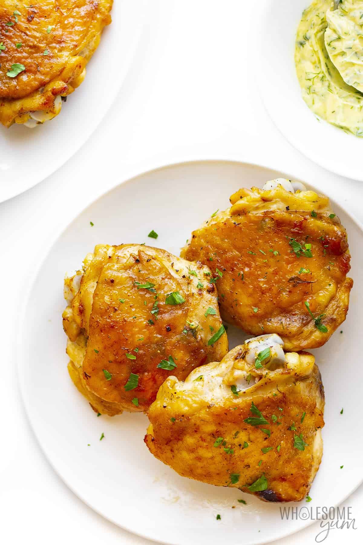 Baked chicken thighs recipe on a plate.