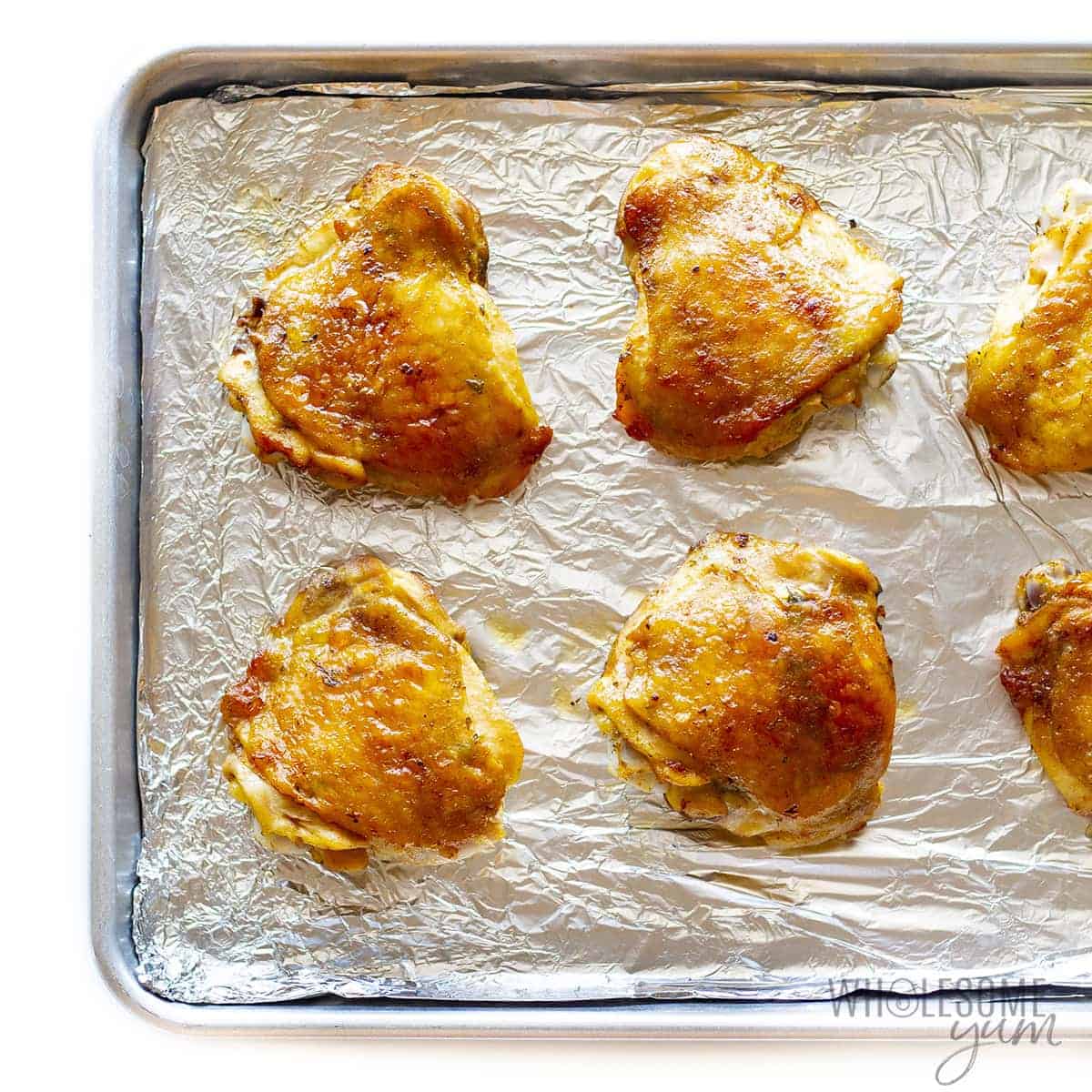 Baked bone-in chicken thighs on a sheet pan